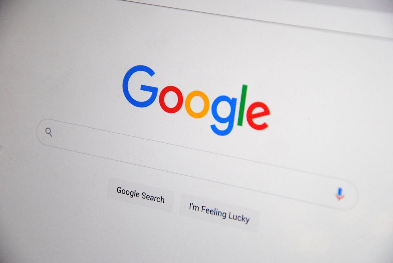 why-choose-us Close-up of the Google homepage on a screen showing search options.
